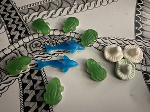 The frogs have cornered the two sharks, who are fearing for their life.