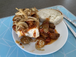 The lunch of the day is meatballs, with tomato and sauteed onions, on B&uuml;rrli