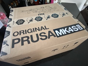 The Prusa MK4S package arrived, and I'm wiggling on my seat to get it built.