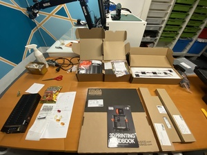 The Prusa MK4S kit in a disassembled state. All of these boxes and bags somehow fit together to make a full functioning 3D printer.