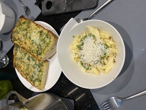 The finished product: garlic bread with cafe de paris, and pasta with green pesto.