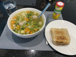 A nice bowl of vegetable soup with meatballs and toast (and Aromat)