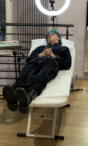 Quinn lies patiently as his ears get two new piercings. What a hero!