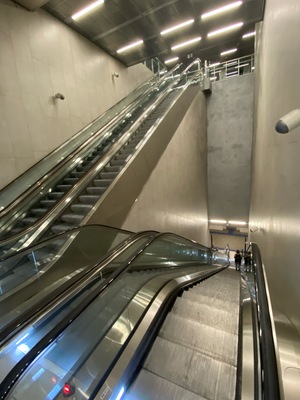 The empty subway station escalators feel like Liminal Spaces to Quinn