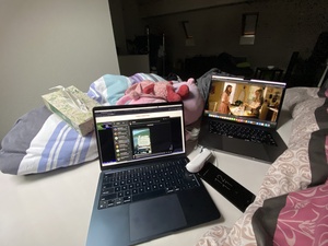 The view from my bed: Young Sheldon on one laptop, Hugo website on the other.