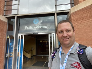 A selfie at the front door of the UPC Edifici Vertex building of UPC in Barcelona.